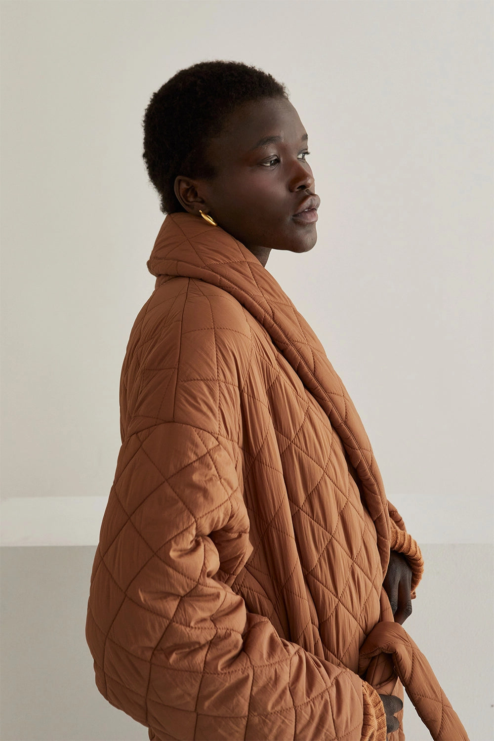 close up side view womens Quilted long  Puffer Wrap Coat in brown